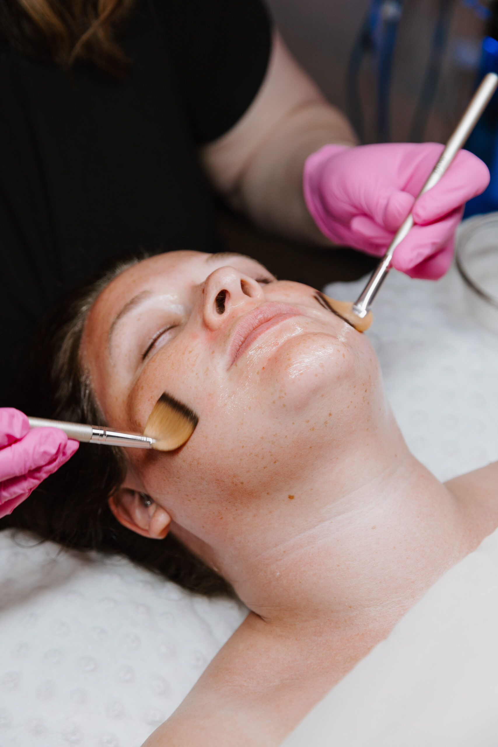 Woman enjoying a facial by Esthetics by Catie